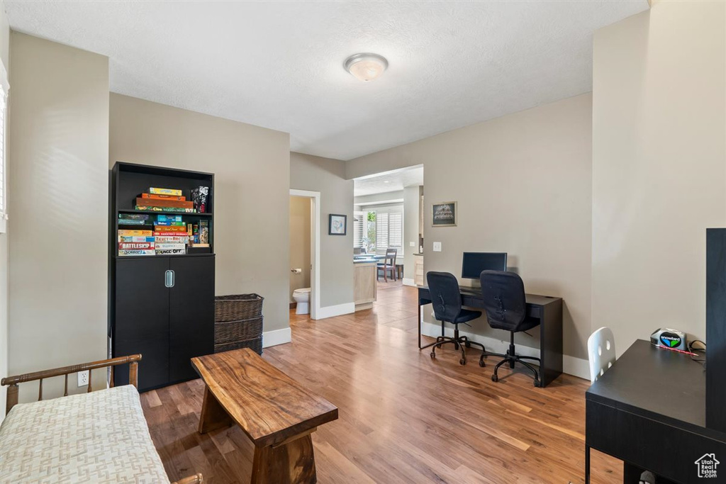 Home office featuring baseboards and light wood-type flooring