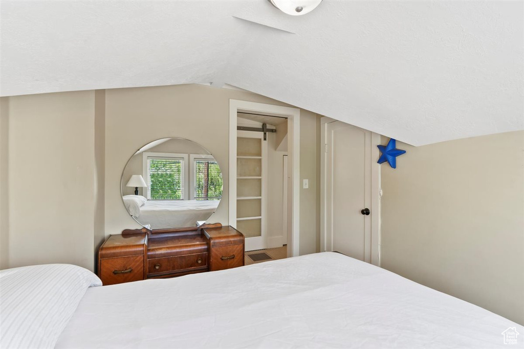 Bedroom with vaulted ceiling