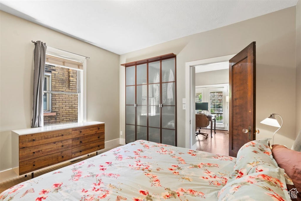 Bedroom featuring baseboards and multiple windows