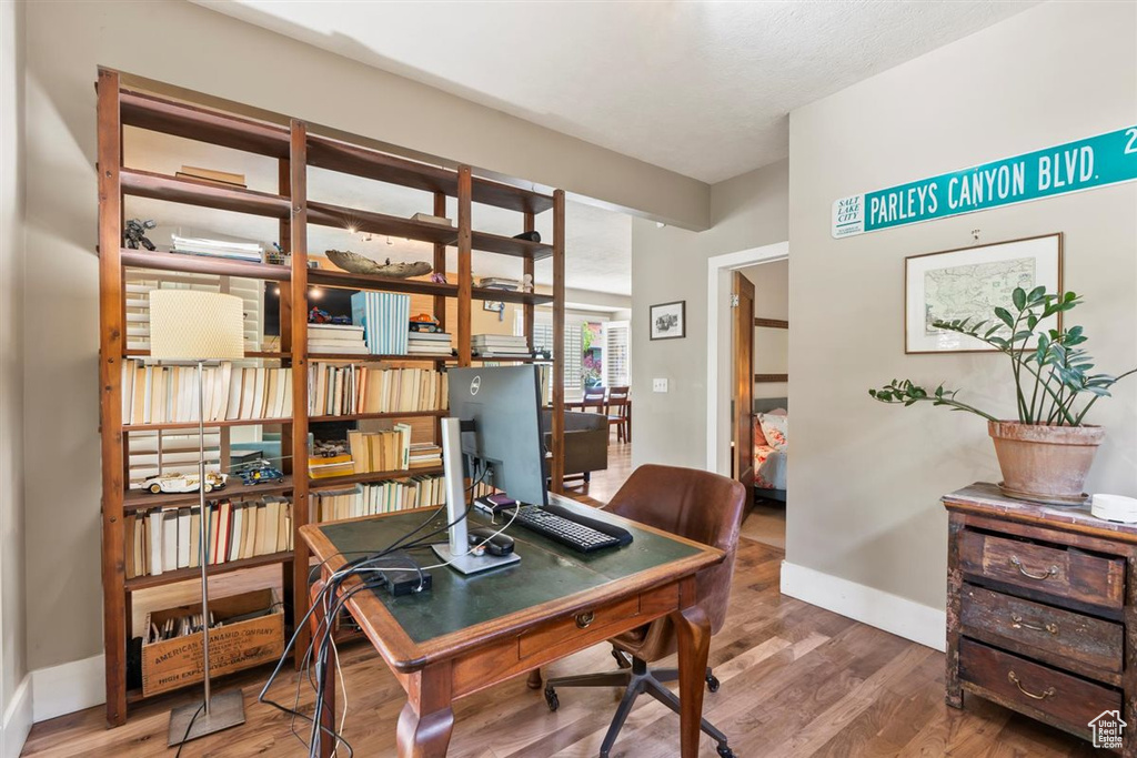 Office with baseboards and wood finished floors