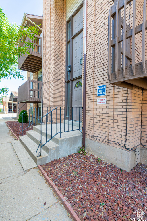 Doorway to property with brick siding