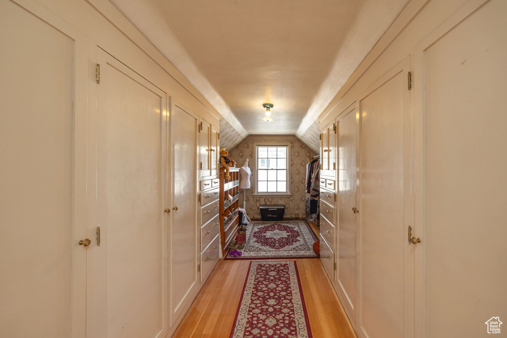 Hall featuring vaulted ceiling and light wood finished floors