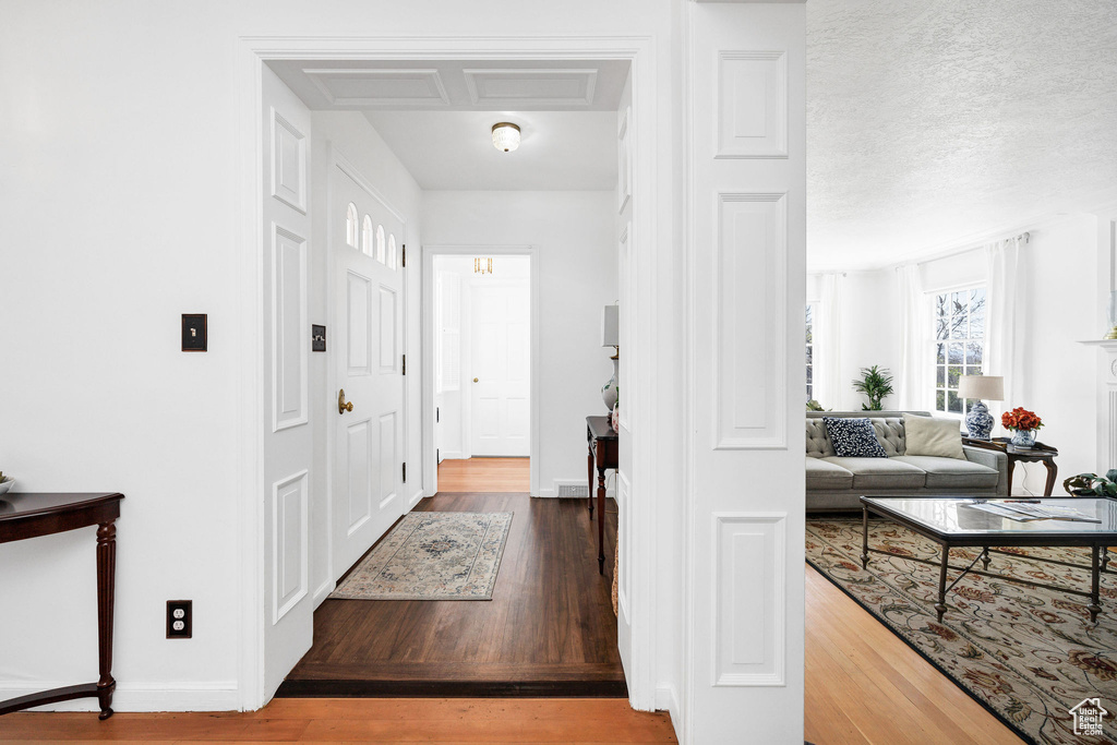 Entryway with wood finished floors and baseboards