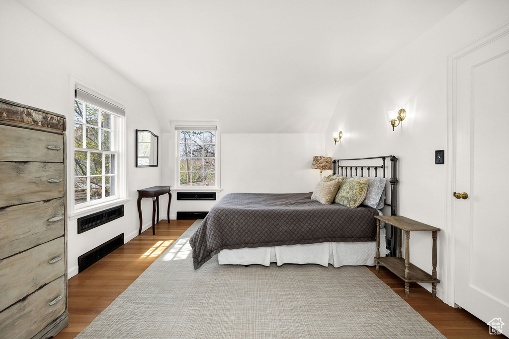 Bedroom featuring vaulted ceiling and wood finished floors