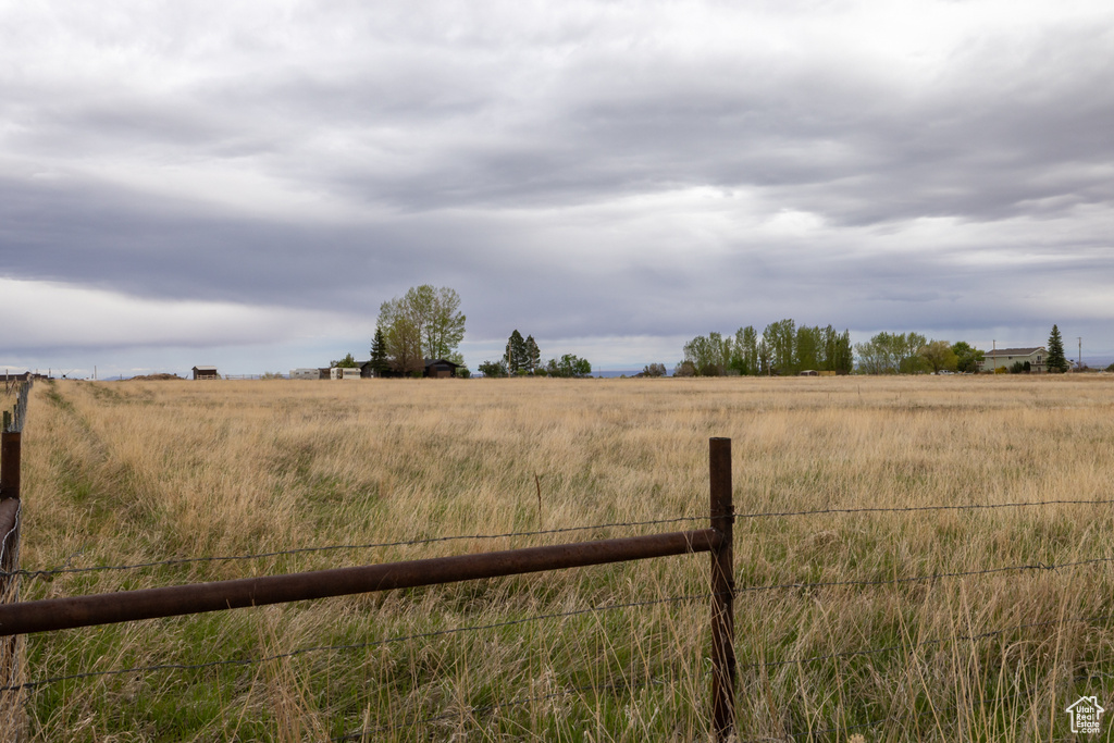 View of yard featuring fence and a rural view