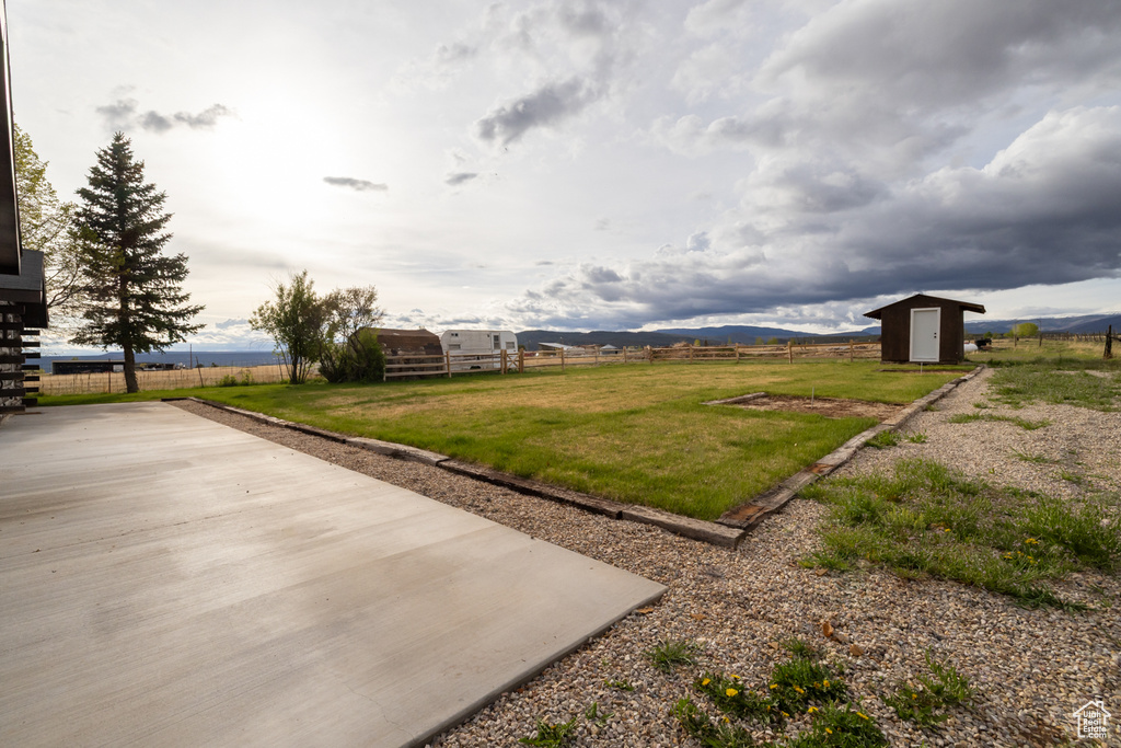 View of yard featuring a storage unit and an outdoor structure