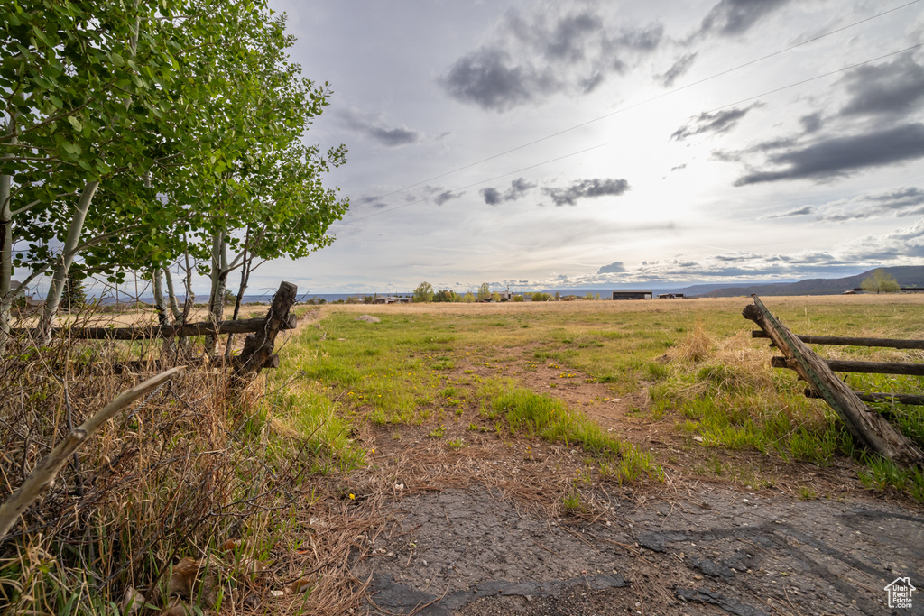 View of yard featuring a view of countryside and fence