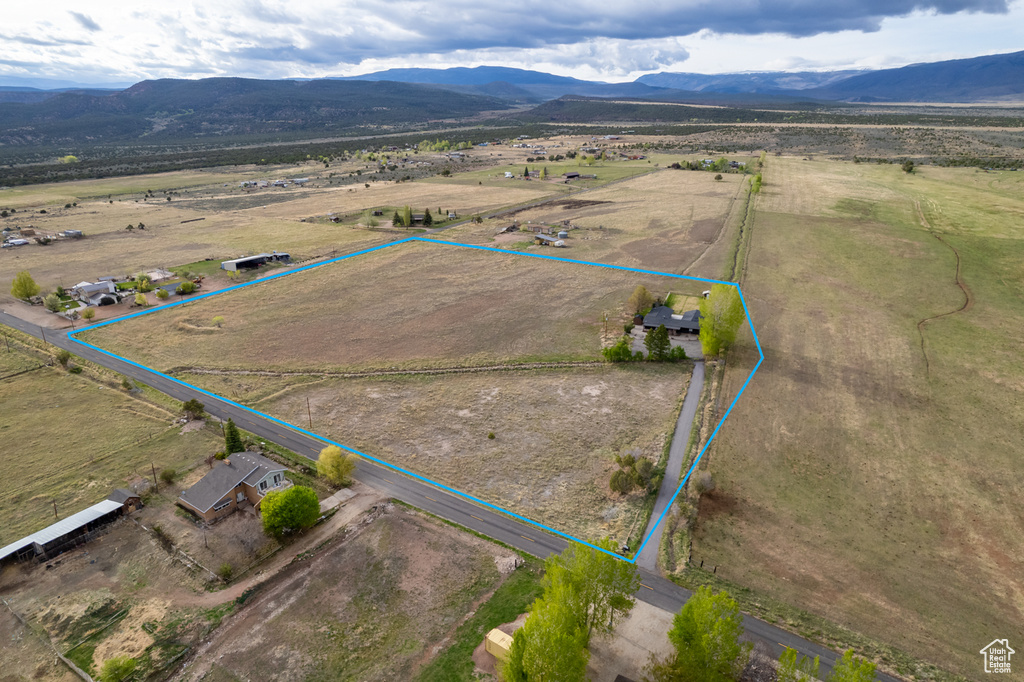 Aerial view of sparsely populated area with property boundaries highlighted and mountains