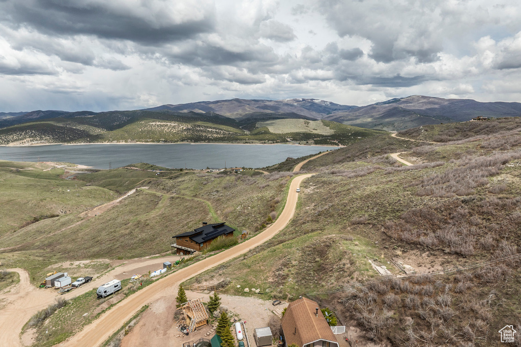 Drone / aerial view featuring a water and mountain view
