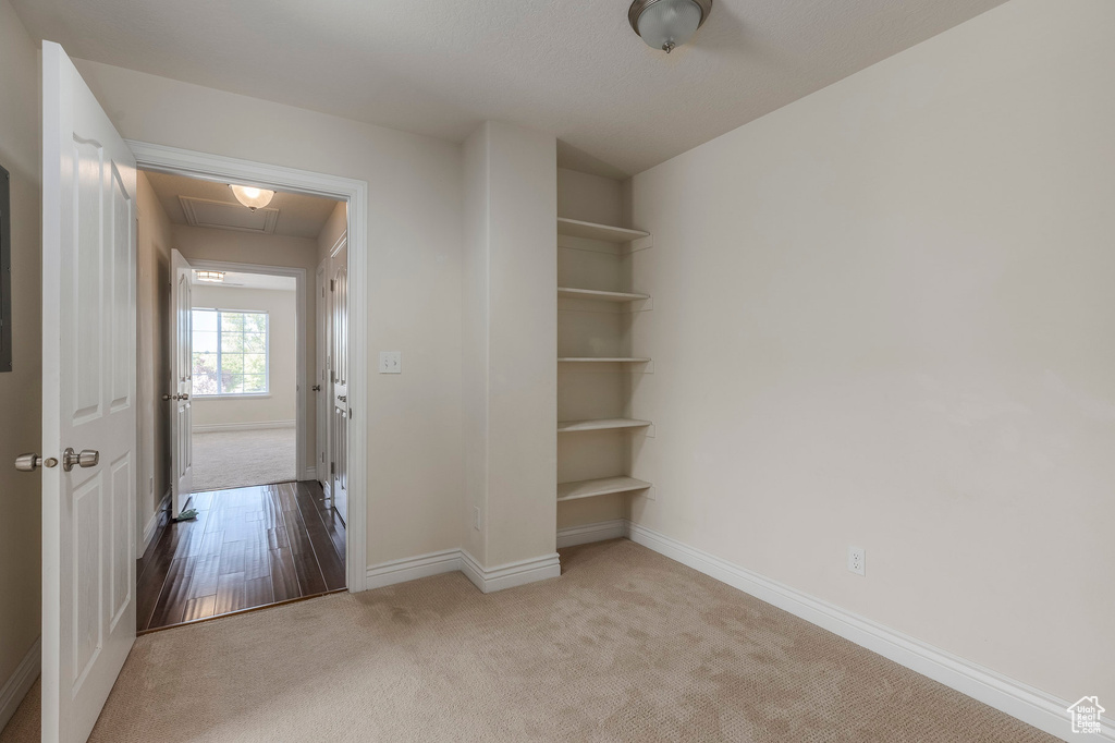Interior space with attic access, baseboards, and carpet floors