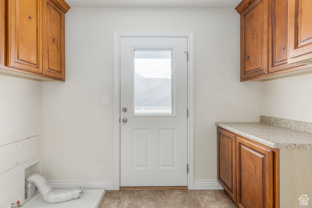 Laundry room featuring cabinet space
