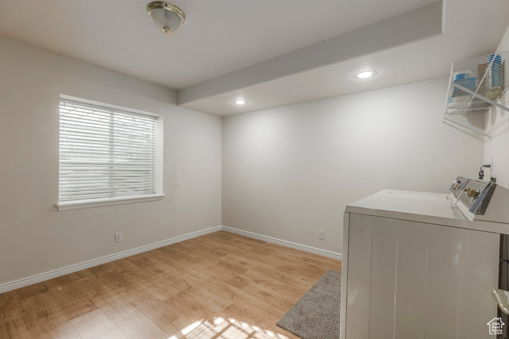 Laundry area featuring separate washer and dryer, recessed lighting, laundry area, and light wood-style floors
