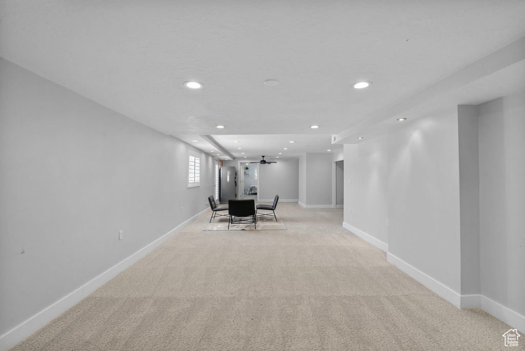 Interior space featuring baseboards, light carpet, and recessed lighting