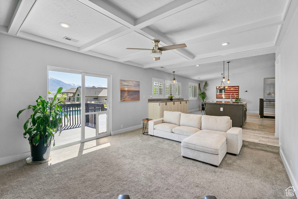 Living area featuring baseboards, recessed lighting, carpet flooring, and visible vents