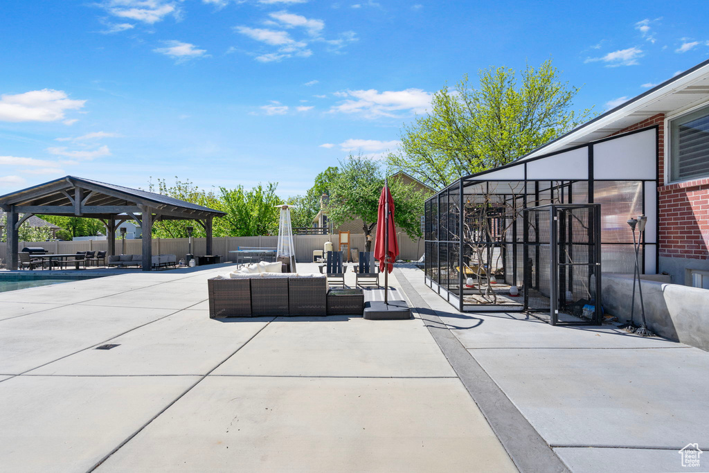View of patio featuring a gazebo, fence, and an outdoor living space