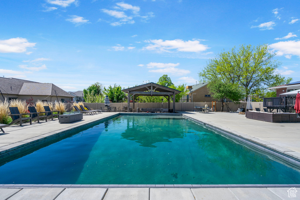 View of swimming pool featuring a gazebo, a patio area, and a fenced backyard