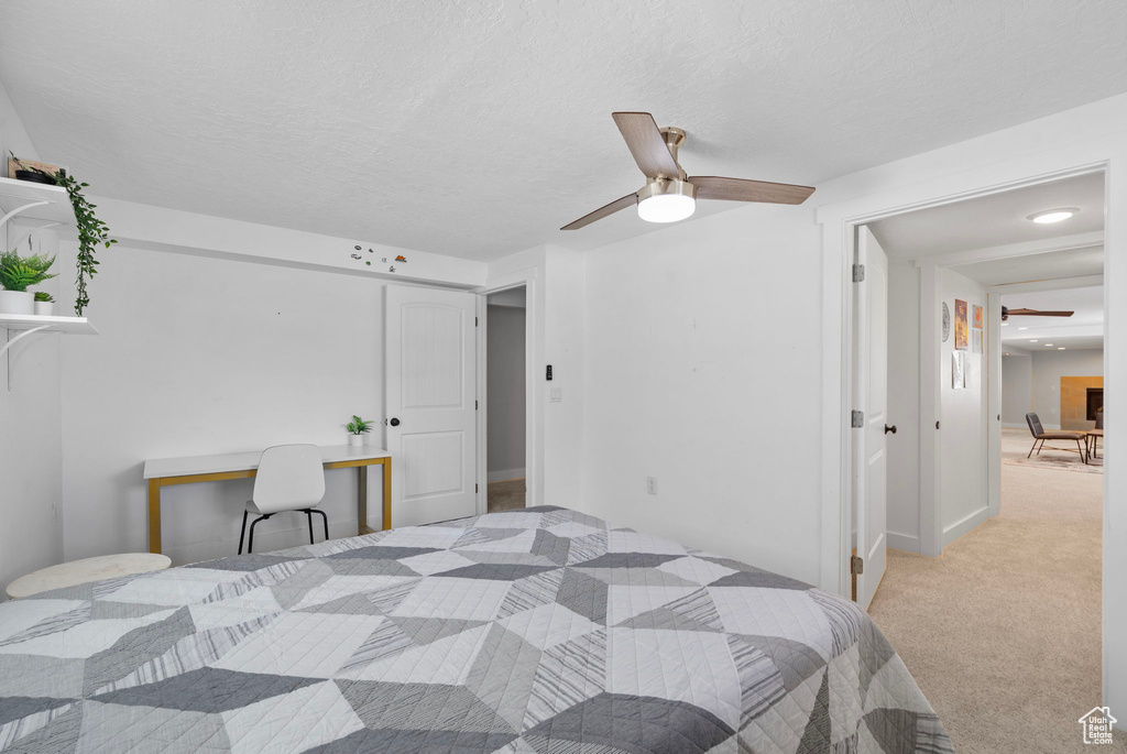 Bedroom featuring ceiling fan and carpet floors