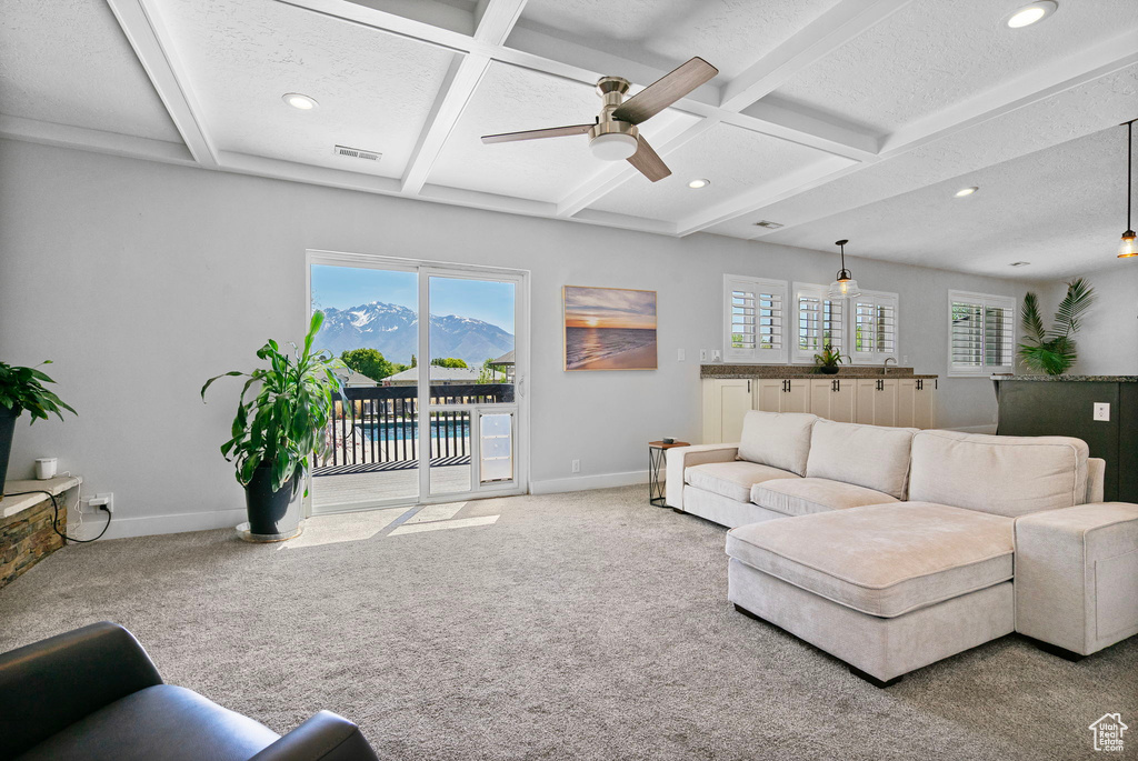 Living room featuring ceiling fan, carpet flooring, baseboards, and recessed lighting