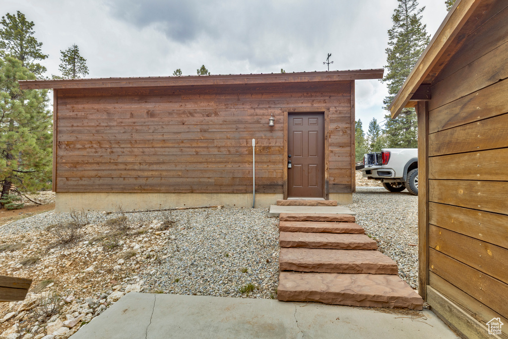 View of outbuilding featuring fence