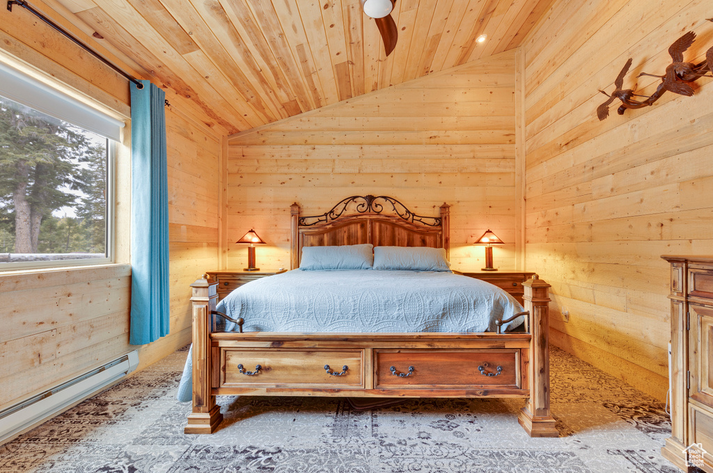 Bedroom with baseboard heating, wood walls, wood ceiling, and vaulted ceiling
