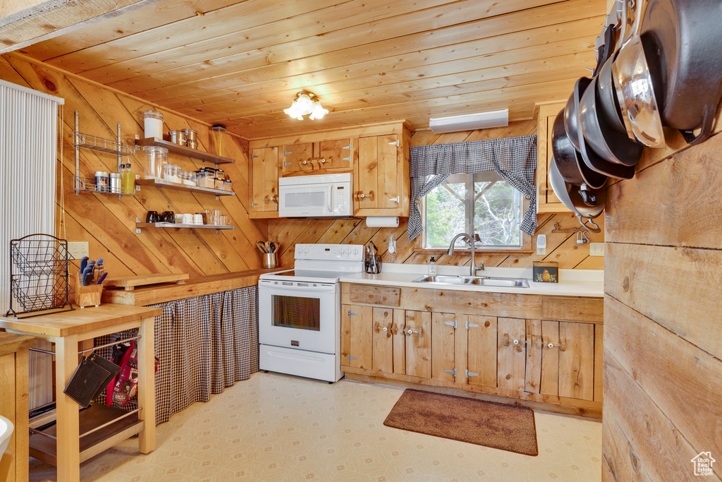 Kitchen with a sink, open shelves, light floors, white appliances, and wooden ceiling