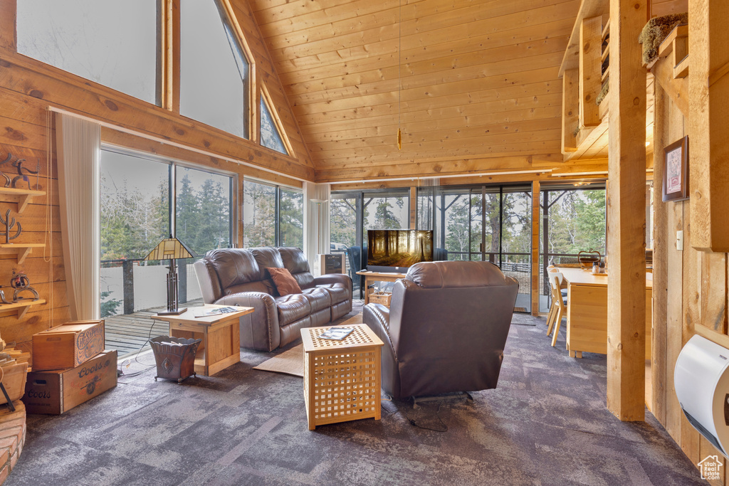 Sunroom with carpet flooring, wood walls, high vaulted ceiling, and wood ceiling