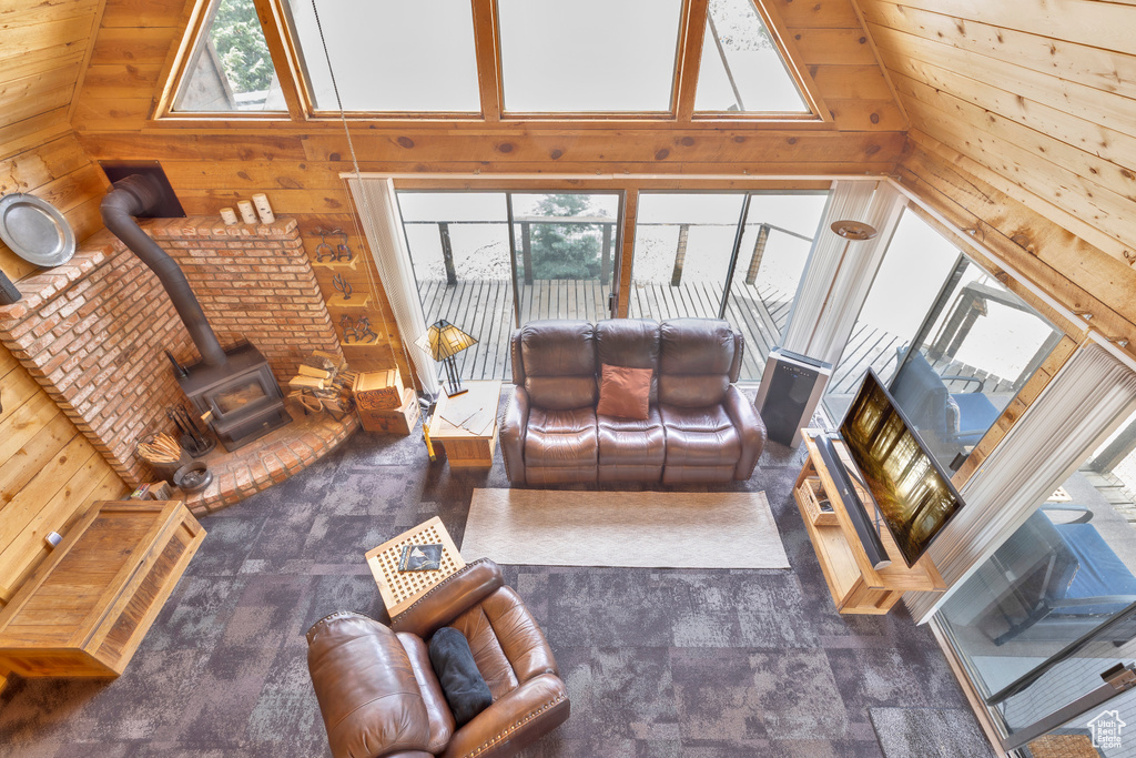 Living area with a wood stove and wooden walls