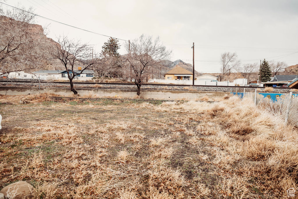 View of yard featuring fence