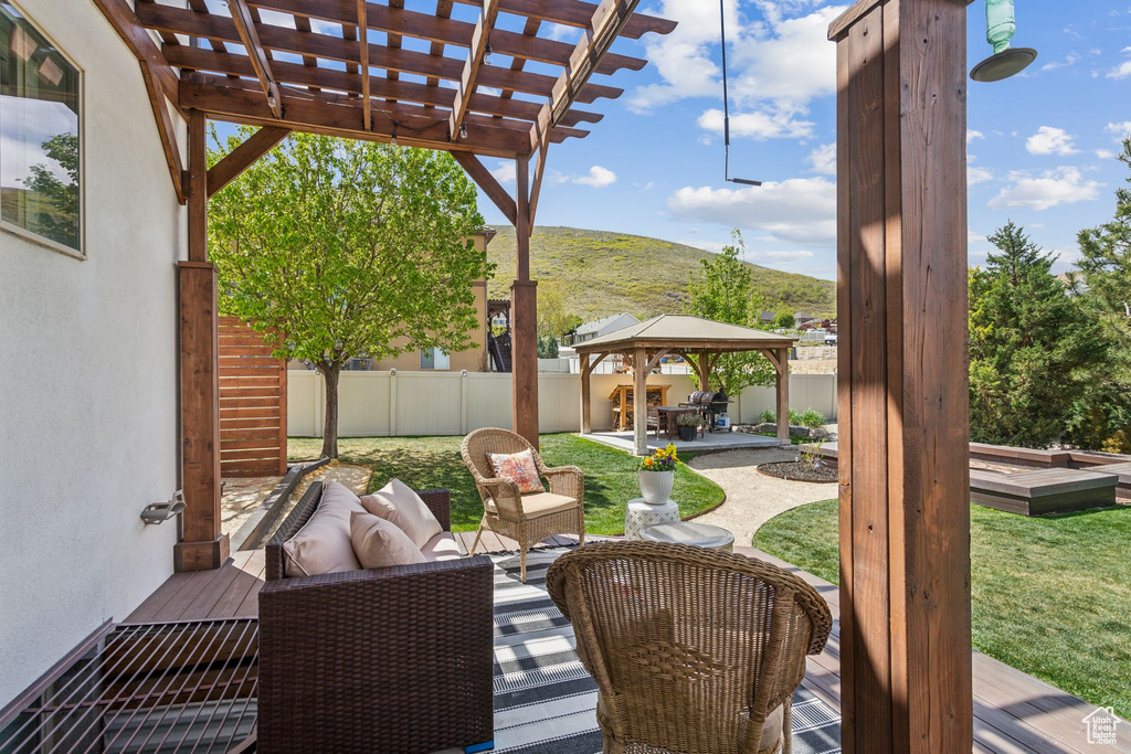 View of patio featuring a mountain view, a pergola, a gazebo, and a fenced backyard