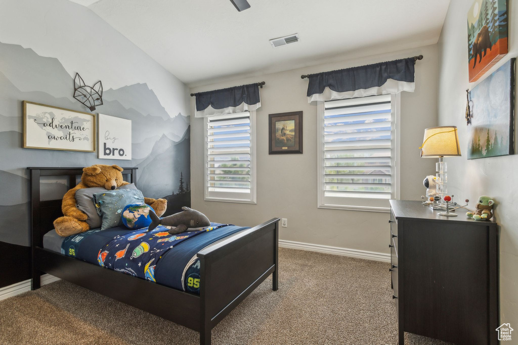 Carpeted bedroom with baseboards and visible vents