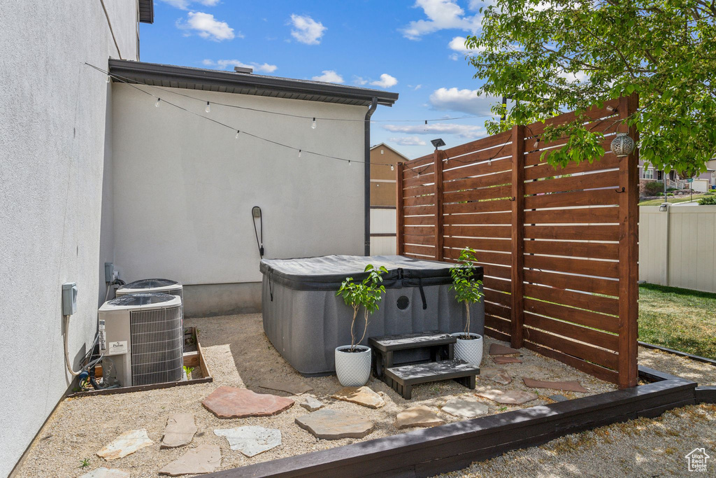 Details featuring central AC unit, fence, and a jacuzzi