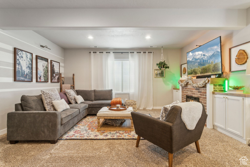Living room featuring light colored carpet, a fireplace, and recessed lighting