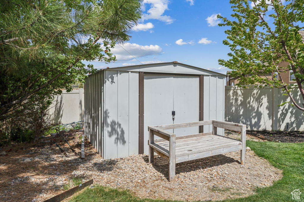 View of shed featuring fence