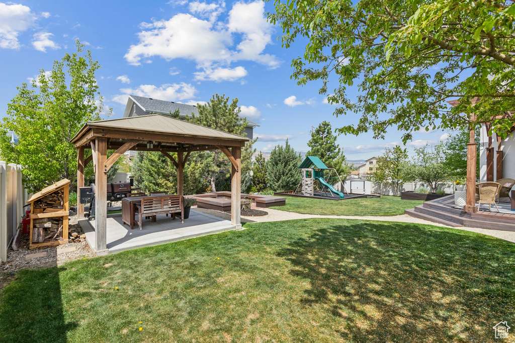 View of yard with an outdoor hangout area, a gazebo, a playground, and a fenced backyard