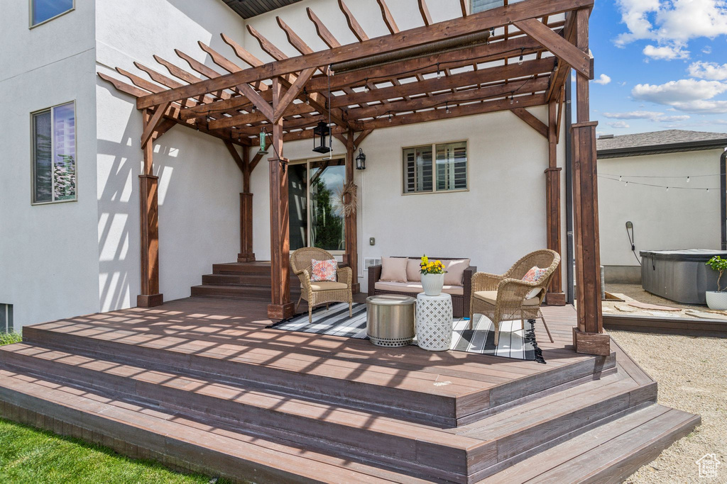 View of patio with a pergola, a deck, and an outdoor living space