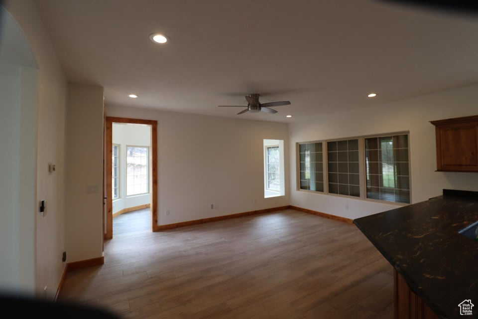 Interior space featuring recessed lighting, baseboards, a ceiling fan, and wood finished floors
