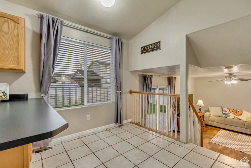 Dining area with baseboards, a ceiling fan, visible vents, and high vaulted ceiling