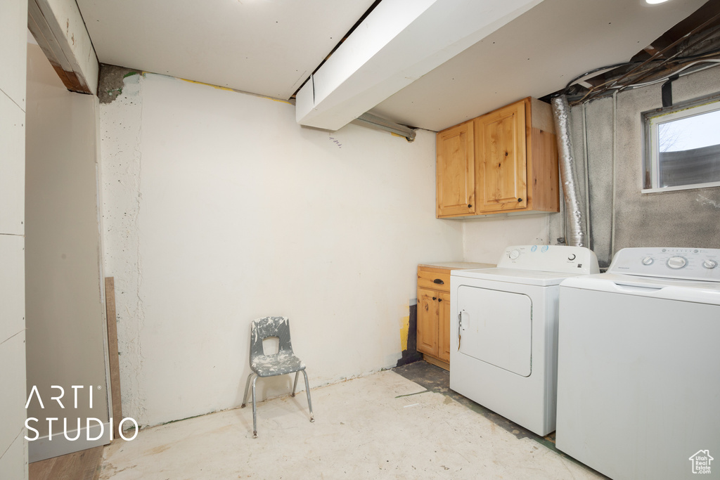 Laundry area featuring washing machine and dryer and cabinet space