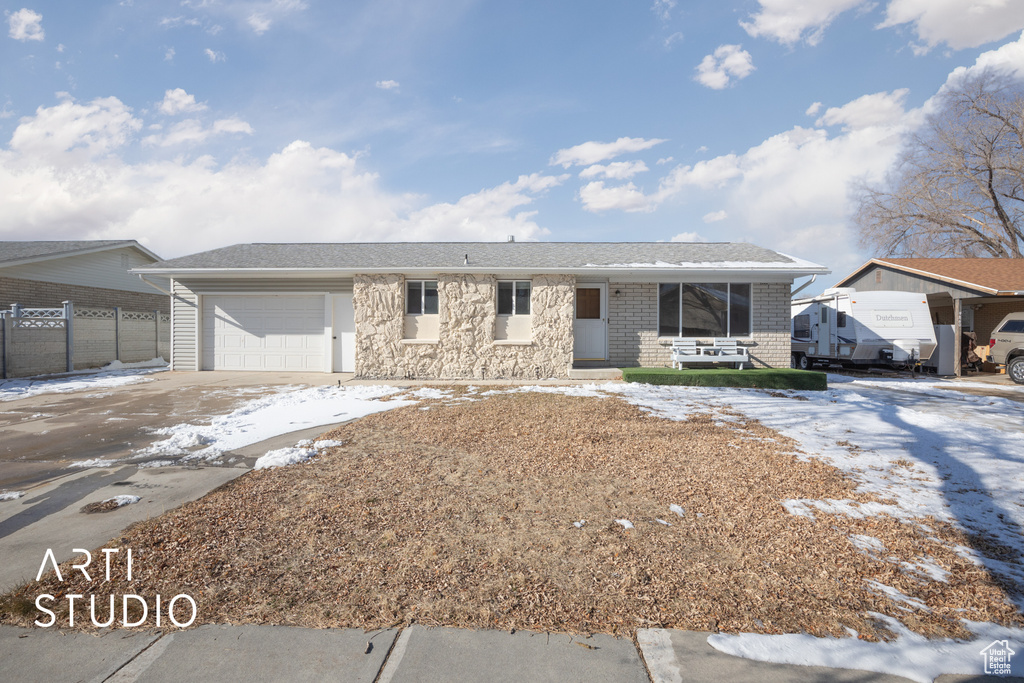 Ranch-style home with concrete driveway, a garage, and fence