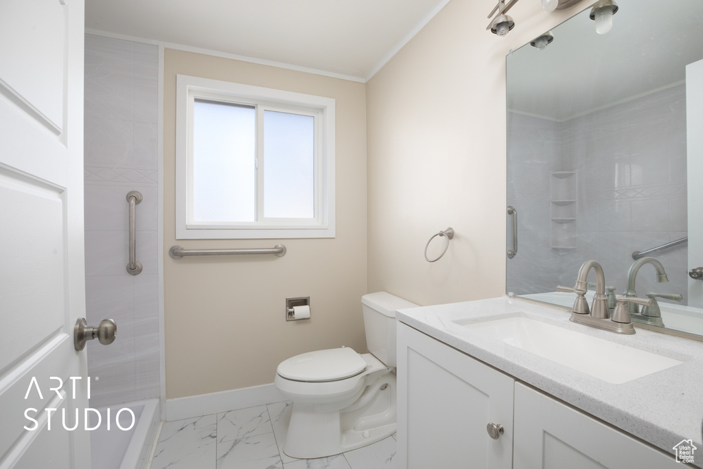 Bathroom with toilet, baseboards, walk in shower, marble finish floor, and vanity