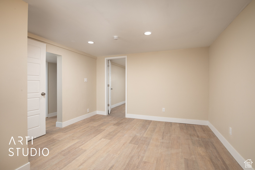 Spare room with light wood-style flooring, baseboards, and recessed lighting