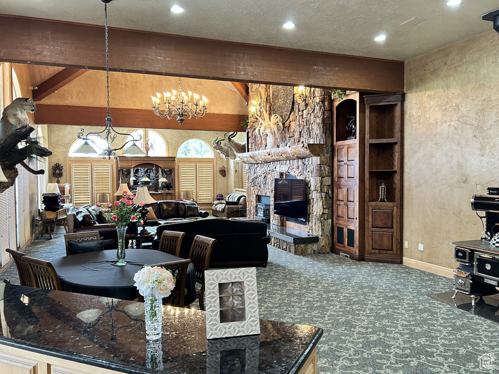 Carpeted living room with recessed lighting, baseboards, an inviting chandelier, arched walkways, and a textured wall