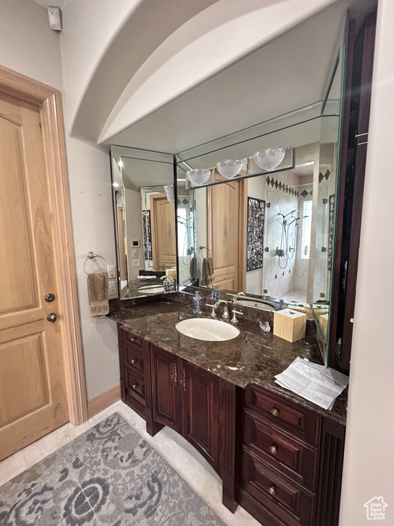 Full bathroom with a shower stall, tile patterned flooring, and vanity