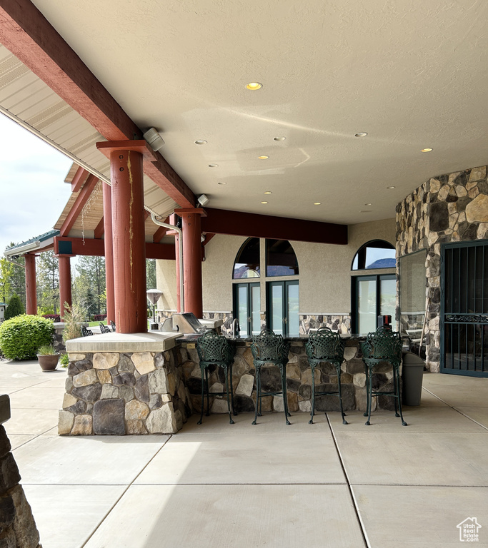 View of patio / terrace with area for grilling, french doors, and outdoor wet bar