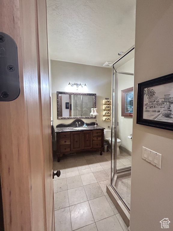 Bathroom featuring tile patterned floors, toilet, visible vents, and vanity