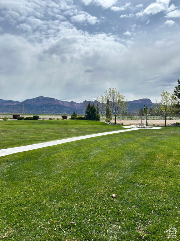 View of community featuring a lawn and a mountain view
