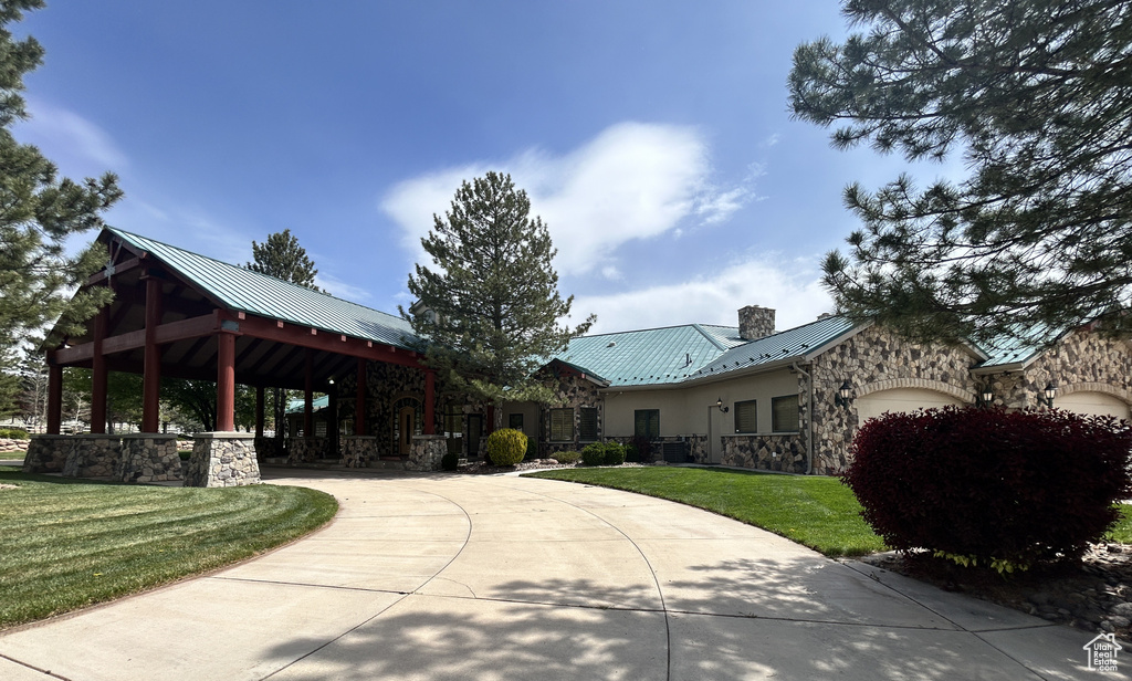 View of community with a garage, a gazebo, and a lawn