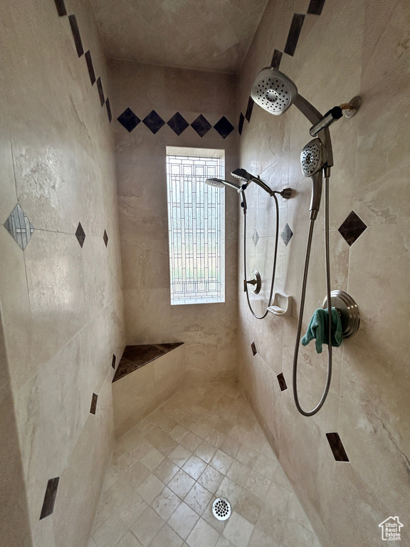 Full bath featuring tiled shower
