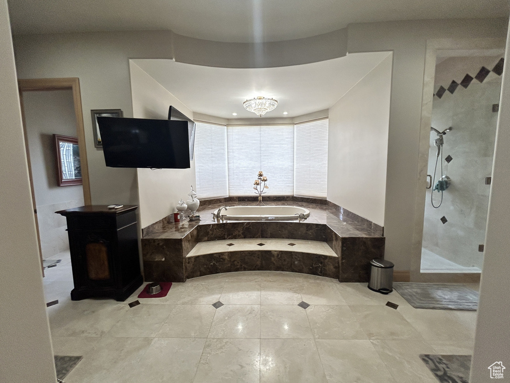 Bathroom featuring a stall shower and a garden tub