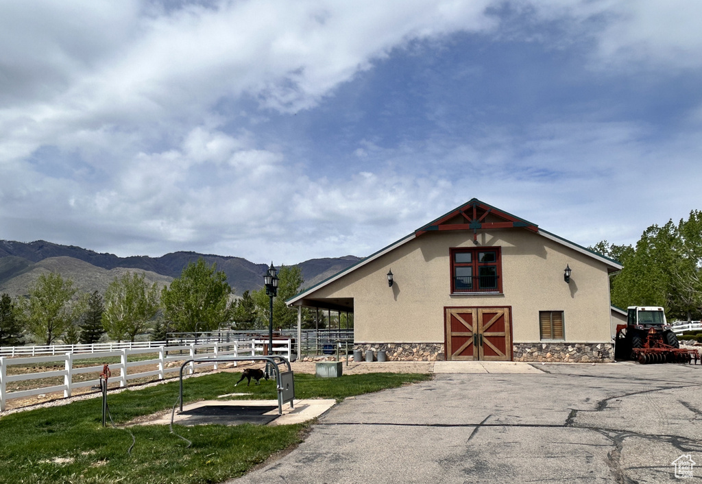 View of horse barn featuring a mountain view